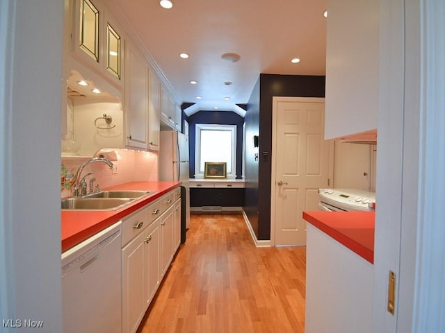 kitchen featuring sink, stainless steel fridge, white dishwasher, decorative backsplash, and white cabinets