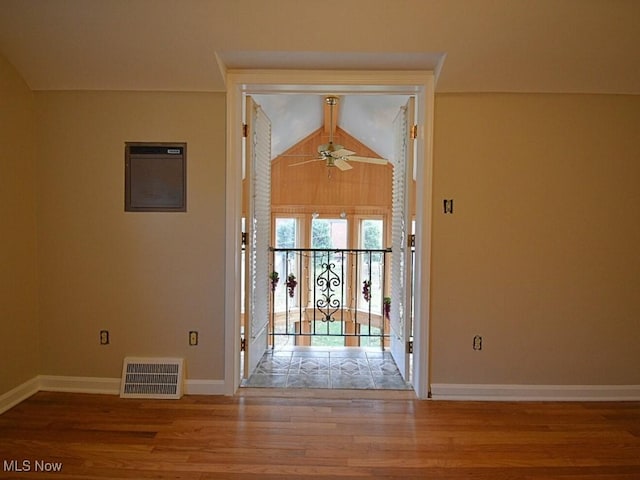 interior space featuring hardwood / wood-style flooring, ceiling fan, and vaulted ceiling