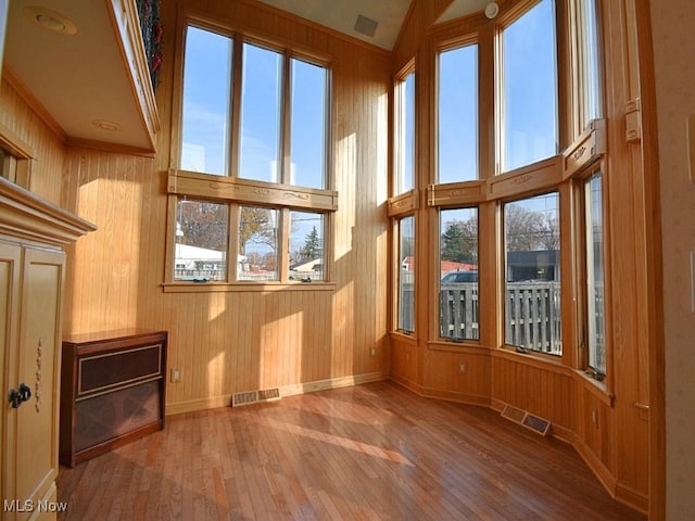 unfurnished sunroom featuring lofted ceiling