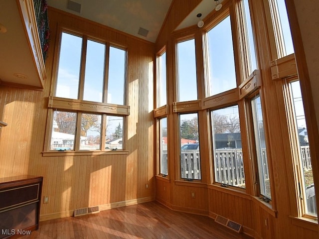 unfurnished sunroom with lofted ceiling