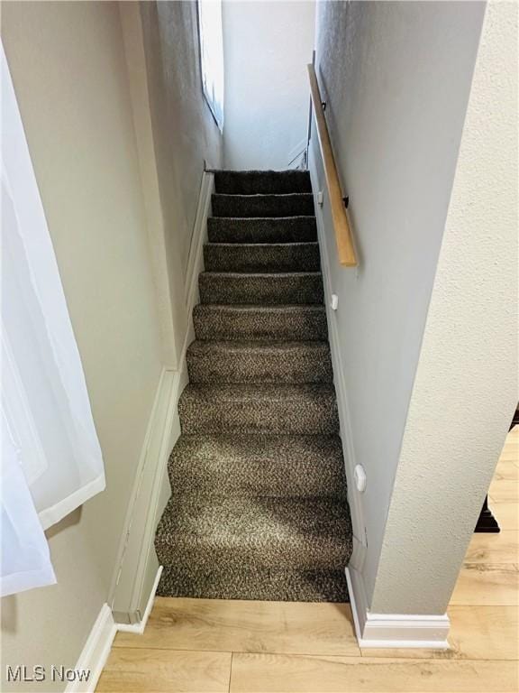 stairway featuring wood-type flooring