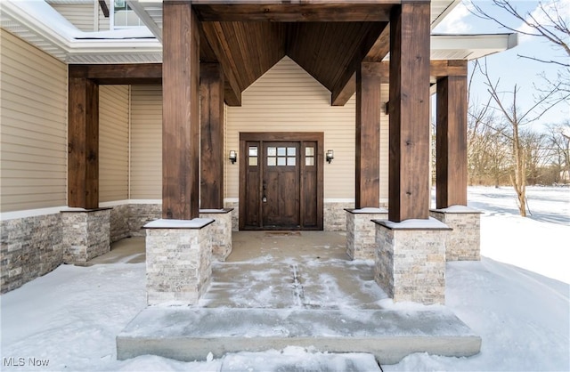 view of snow covered property entrance