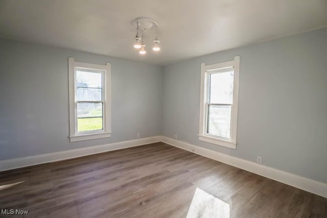 unfurnished room featuring hardwood / wood-style flooring