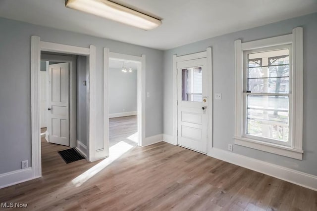 foyer featuring hardwood / wood-style flooring and a notable chandelier