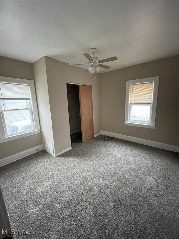 unfurnished bedroom with ceiling fan and carpet floors