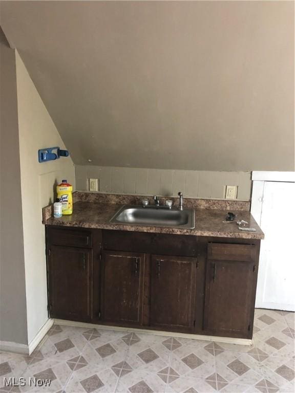 bathroom with sink and vaulted ceiling