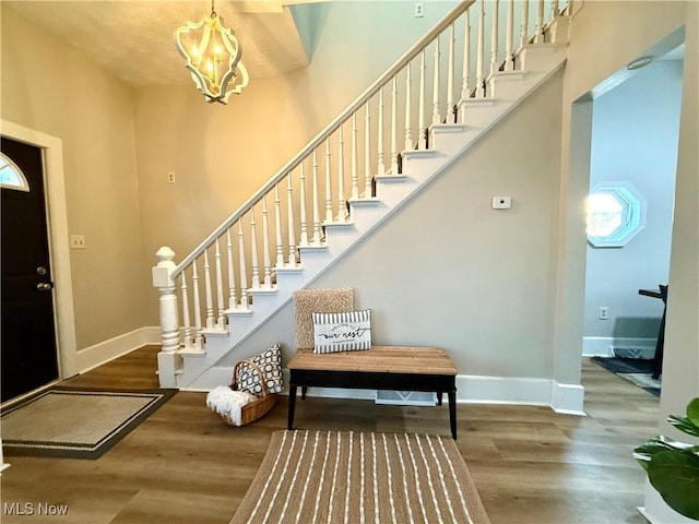 foyer featuring hardwood / wood-style flooring and an inviting chandelier