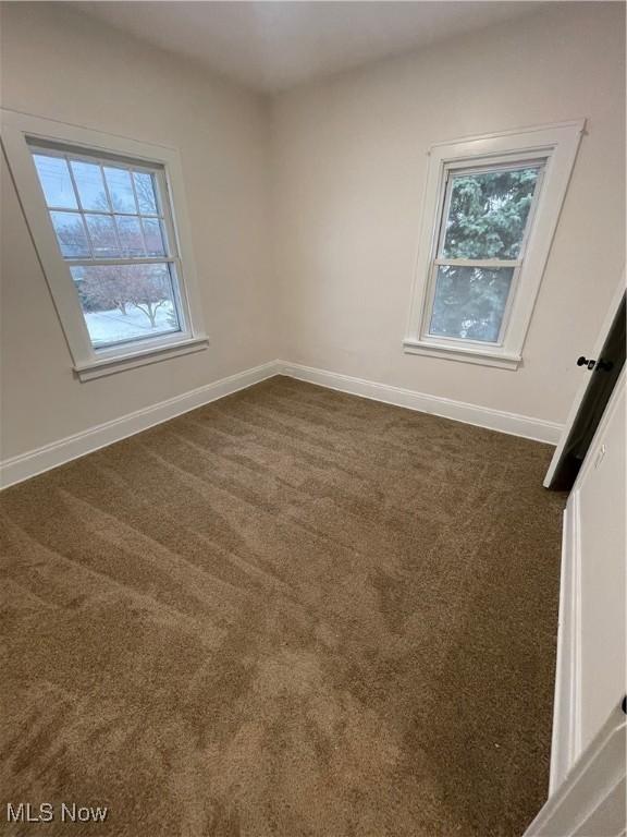 empty room with dark carpet