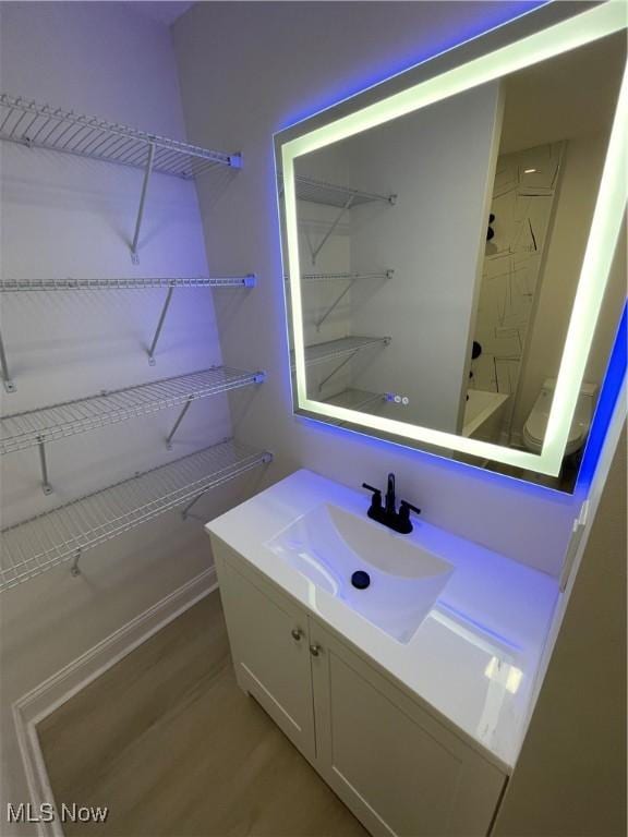 bathroom with vanity, shower / bathtub combination, and hardwood / wood-style flooring