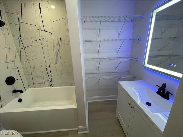 bathroom featuring bathtub / shower combination, vanity, and hardwood / wood-style flooring