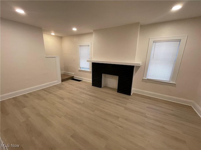 unfurnished living room featuring light hardwood / wood-style floors