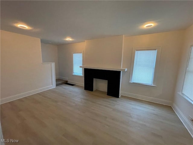 unfurnished living room featuring light hardwood / wood-style flooring