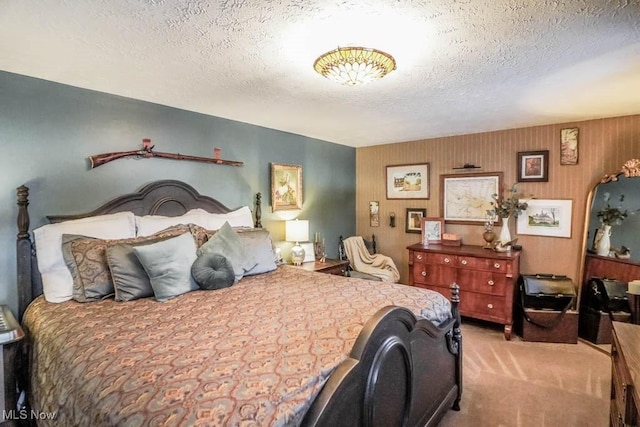 bedroom featuring light colored carpet and a textured ceiling