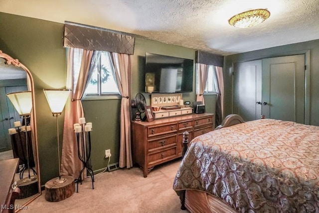 carpeted bedroom featuring a closet and a textured ceiling