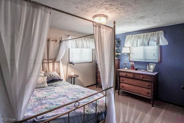 bedroom featuring a textured ceiling and carpet floors