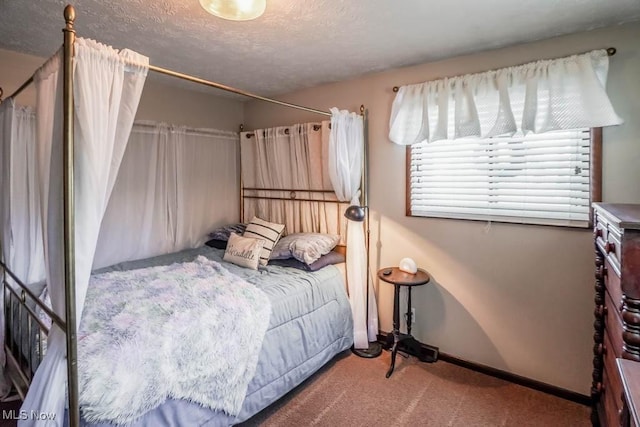 bedroom with carpet floors and a textured ceiling