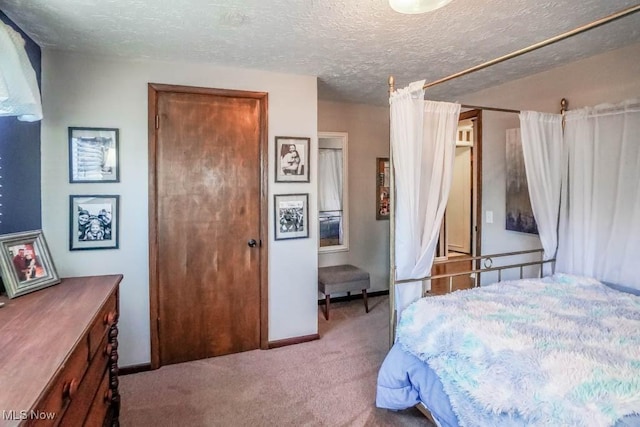 carpeted bedroom with a textured ceiling