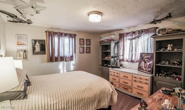 carpeted bedroom featuring a textured ceiling