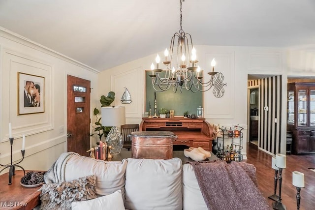 living room with crown molding, dark wood-type flooring, and a notable chandelier