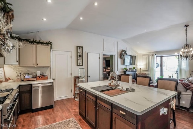 kitchen featuring light stone countertops, sink, lofted ceiling, and appliances with stainless steel finishes