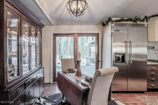 interior space featuring dark hardwood / wood-style flooring and an inviting chandelier