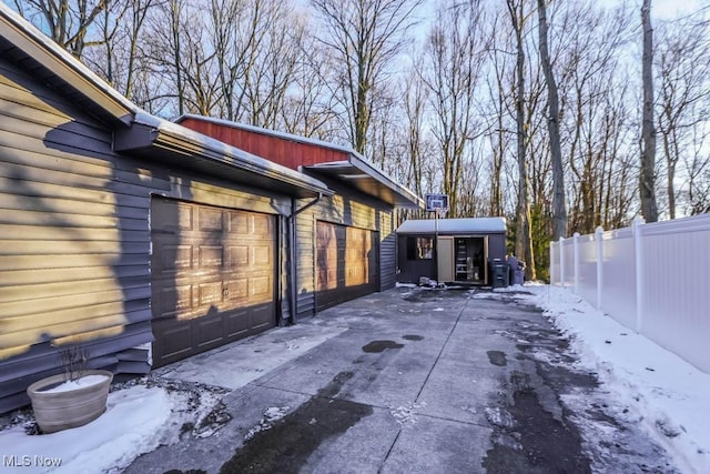 snow covered property featuring a garage