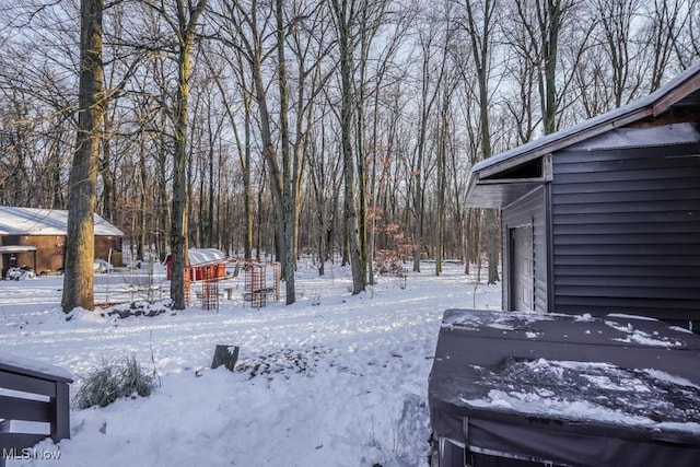 yard layered in snow featuring a garage