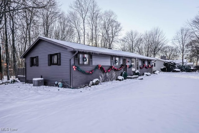 view of snowy exterior with central AC