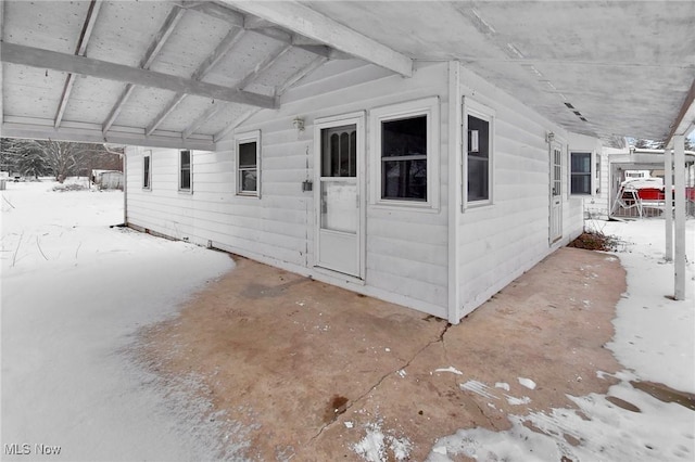 view of snow covered property entrance