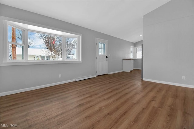 interior space with dark hardwood / wood-style floors, baseboard heating, and vaulted ceiling