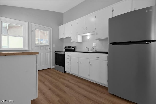 kitchen featuring light hardwood / wood-style floors, sink, white cabinetry, and stainless steel appliances