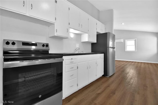 kitchen featuring lofted ceiling, white cabinets, sink, appliances with stainless steel finishes, and dark hardwood / wood-style flooring