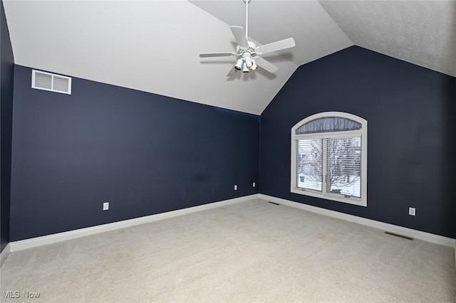 carpeted empty room with ceiling fan and vaulted ceiling