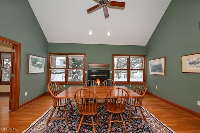 dining room featuring light wood-type flooring, a wealth of natural light, and ceiling fan