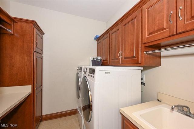 2142 Kirtland Pl, Hudson, OH 44236 - laundry area featuring cabinet space, washer and clothes dryer, baseboards, and light tile patterned flooring