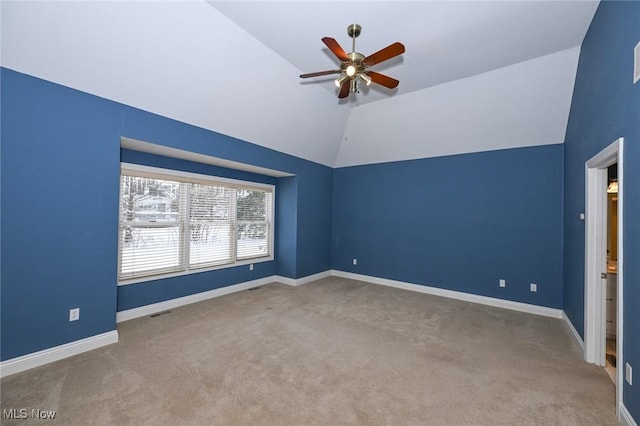 empty room with carpet flooring, ceiling fan, and vaulted ceiling