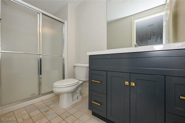 bathroom featuring vanity, an enclosed shower, and toilet