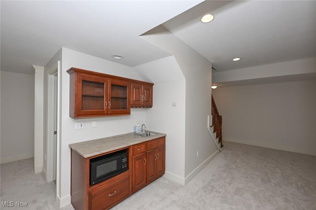 bar with light carpet, sink, and lofted ceiling