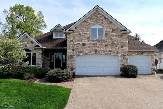 2142 Kirtland Pl, Hudson, OH 44236 - view of front facade with stone siding, driveway, roof with shingles, and an attached garage