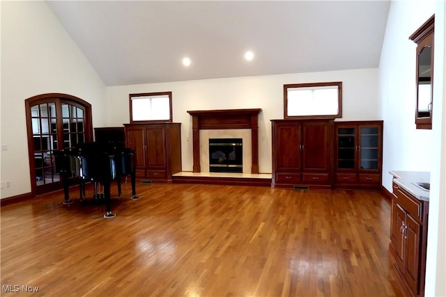 2142 Kirtland Pl, Hudson, OH 44236 - living area featuring wood finished floors, lofted ceiling, a high end fireplace, arched walkways, and recessed lighting
