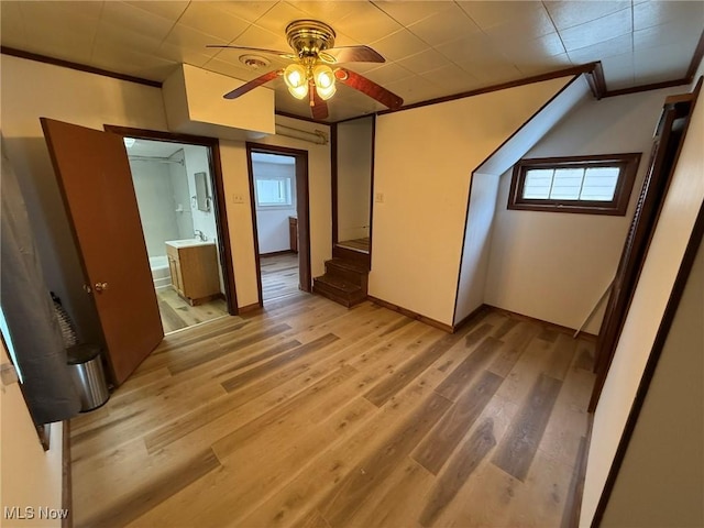 bonus room with ceiling fan, plenty of natural light, and wood-type flooring