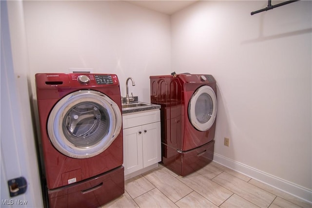 laundry room with cabinets, sink, and washing machine and clothes dryer