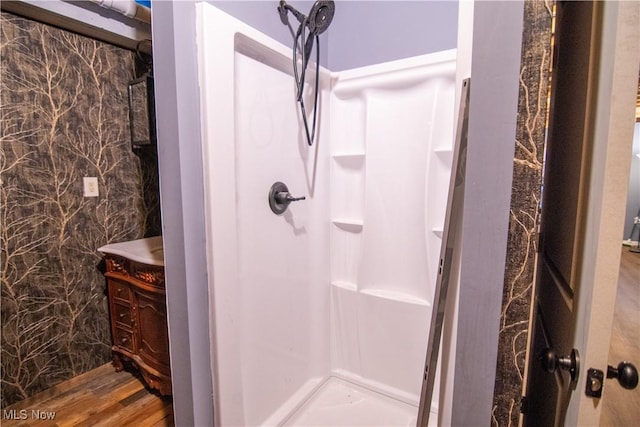 bathroom featuring a shower and hardwood / wood-style flooring