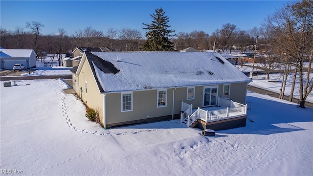 view of snow covered rear of property