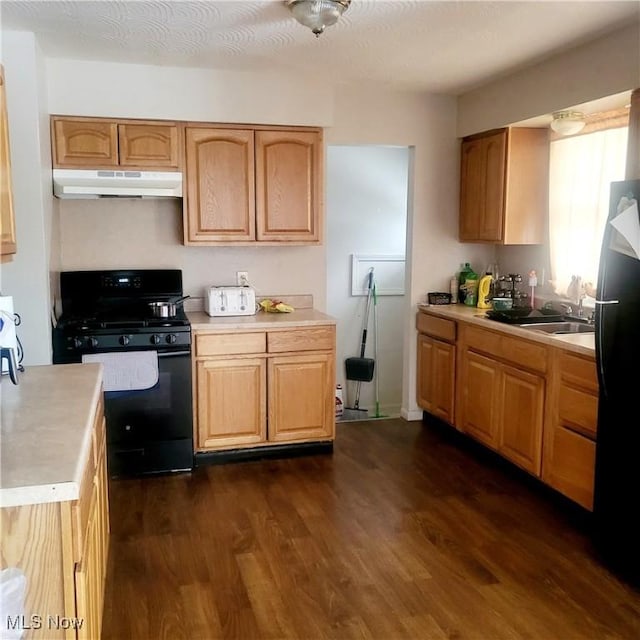 kitchen featuring black appliances, dark hardwood / wood-style floors, sink, and a textured ceiling