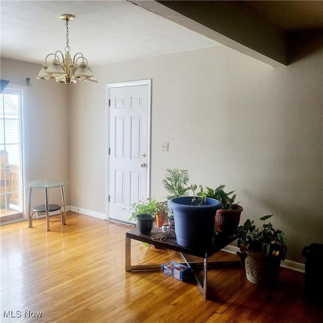 interior space featuring hardwood / wood-style floors and a notable chandelier