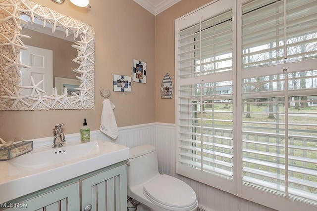 bathroom with vanity, toilet, and crown molding