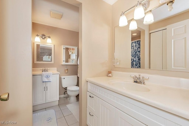 bathroom featuring tile patterned floors, vanity, and toilet