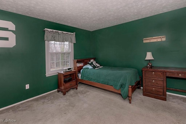 carpeted bedroom featuring a textured ceiling