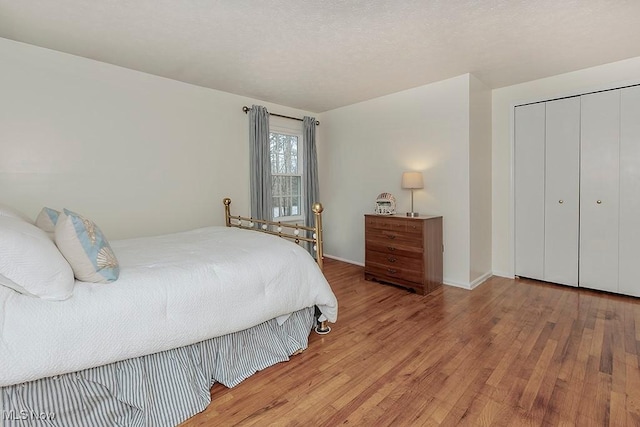 bedroom with hardwood / wood-style flooring and a closet